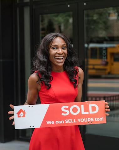 Lady in red with sold sign